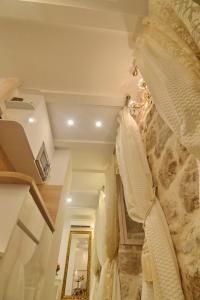 a bedroom with a white bed and a mirror at Villa Madonna della Strada A3 in Dubrovnik
