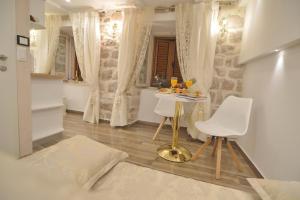 a room with a table and two white chairs at Villa Madonna della Strada A3 in Dubrovnik