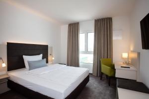 Postel nebo postele na pokoji v ubytování Hotel am Campus + 35 fotografií