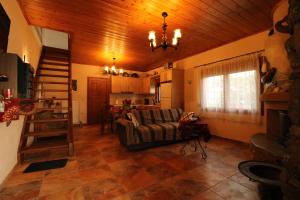 a living room with a couch and a kitchen at Fakistra's Blue House in Tsagarada