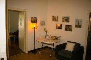 a room with a table and a lamp and a chair at Xanthis Hostel Nicosia City Centre in Nicosia
