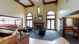 a large living room with chairs and a fireplace at Chase Suite Hotel Newark Fremont in Newark