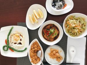 a table with white plates of food on it at David's House in Fanlu