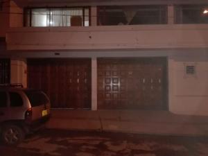 a car parked in front of a building with two garage doors at Family Haclams in Zipaquirá