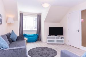 a living room with a couch and a tv at Ailsa Retreat in Troon
