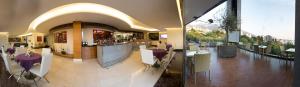 a lobby with tables and chairs in a building at Hotel Xperience in Jounieh