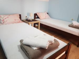 a room with two beds with towels on them at Apartment Matovic in Kragujevac