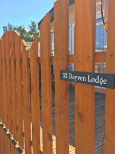 a wooden fence with a sign that reads drawer lodge at 32 Dayven Lodge in Boat of Garten