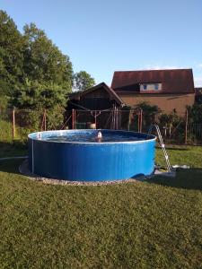 a large blue pool in a yard with a house at Privat Em & Mi in Liptovský Mikuláš