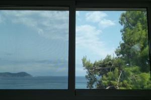 a view of the ocean from a window at Kymi Bay House in Platána