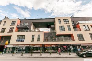 un bâtiment avec une voiture garée devant dans l'établissement Apartamenty Lustrzany, à Kielce