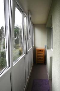 a hallway with a door and a dresser and a window at Relax Inn Druskininkai in Druskininkai