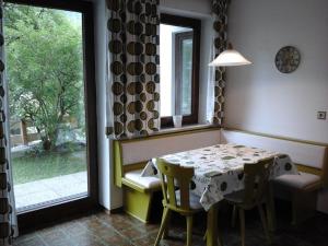 a dining room with a table and chairs and a window at Haus Amalia in Kramsach