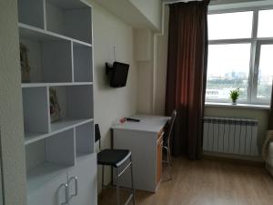 a small room with a desk and a window at Smart-House Smart kvartira s kukhnei vozle metro. in Kyiv