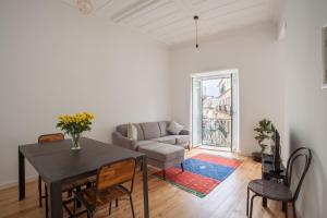 a living room with a table and a couch at BeGuest Santa Catarina Lisbon Apartment in Lisbon