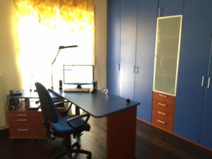 an office with a desk with a computer and a chair at Appartamento Via Gentile in Foggia