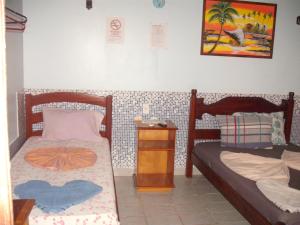 Säng eller sängar i ett rum på Pousada Chalé Suiço