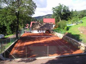 a tennis court in front of a building at Chalupa U Mateje in Trutnov