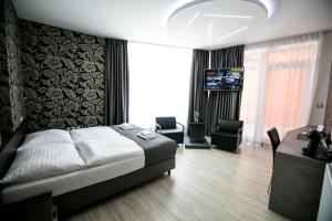 Postel nebo postele na pokoji v ubytování Hotel U Kostela