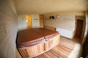 a small room with a large wooden bed in it at Chalupa U Mateje in Trutnov