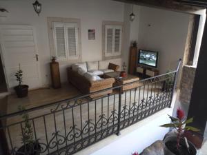 a living room with a couch and a television at Rooms Dana Old Town Budva in Budva