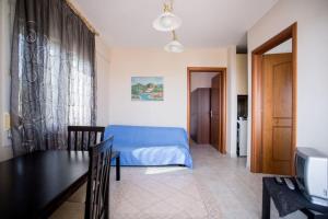 A bed or beds in a room at "By The Sea" Family apartments