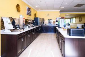 a large kitchen with blue cabinets and a counter top at Asbury Inn & Suites in Wilmore