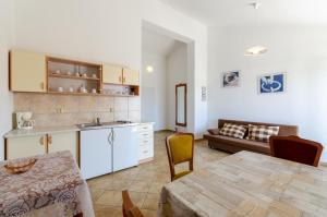 a kitchen and living room with a table and a couch at Apartment in Crikvenica with One-Bedroom 3 in Crikvenica