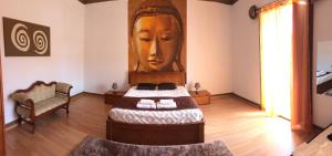 a bedroom with a large head on the wall at Afternoon Desire in Ponta Delgada