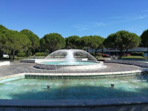 a fountain in the middle of a park at Condominio Moschettieri trilocale in Bibione