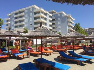 a group of chairs and umbrellas on a beach at Premium Apartaments 02-03 in Vlorë