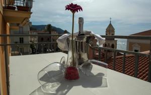 a vase with a flower in it on a balcony at B&B LA PIAZZETTA in Santa Maria di Castellabate