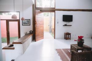 a living room with a door and a tv at Casa Crescente in Trancoso