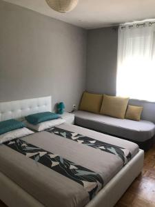 a living room with two beds and a couch at Apartment Vukovarska in Zadar