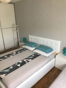 a bed with two pillows on it in a room at Apartment Vukovarska in Zadar