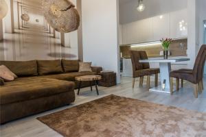 a living room with a couch and a table at Premium Apartment Centrum in Poprad