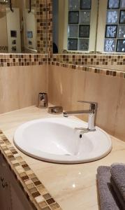 a bathroom with a white sink in a counter at Mini Loft Porto Torres in Porto Torres
