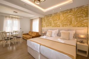 a bedroom with a large bed and a dining room at Splendido MB Apartments in Tivat