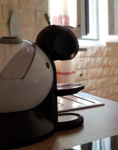 a coffee maker sitting on top of a counter at Mini Loft Porto Torres in Porto Torres +2 photos