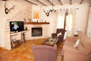 sala de estar con sofá y chimenea en Casas Rurales Cortijo Bellavista, en Alcaraz