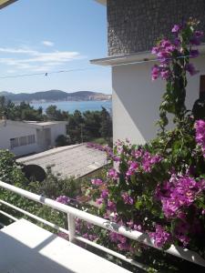 a balcony with purple flowers on the side of a building at Apartments Vretenicic in Bar