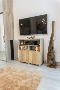 a living room with a flat screen tv on a wall at Premium Apartment Centrum in Poprad