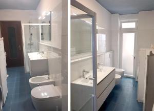 Baño blanco con 2 lavabos y aseo en Seaside holiday apartment - unique location, en Cipressa