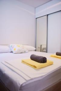 a bedroom with two beds with towels and a mirror at Luxury Apartment Luka in Omiš