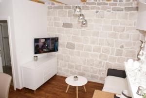 a living room with a stone wall at Luxury Apartment Luka in Omiš