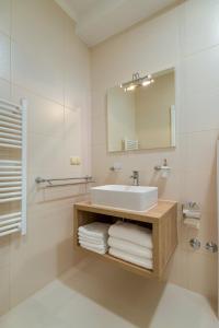 a bathroom with a sink and a mirror and towels at Apartments & Studios Dalmatino in Vodice +100 photos