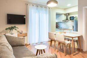 a living room with a couch and a table at Apartments & Studios Dalmatino in Vodice
