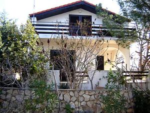 a white house with a fence in front of it at Vesna Pag Potočnica in Borovići