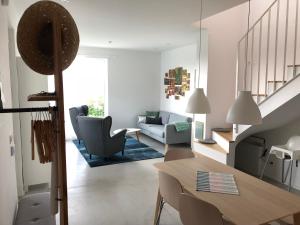 a living room with a table and chairs and a staircase at Annabel Villa in Eger