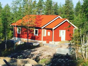 a house being constructed with an orange roof at Fjällhus 3 in Idre